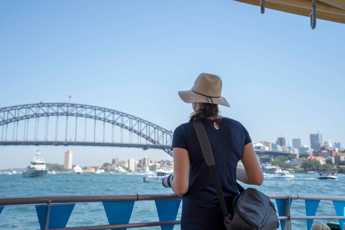 lady-on-ferry-with-hat-on-looking-at-the-view-of-s-2023-11-27-05-37-25-utc (1)