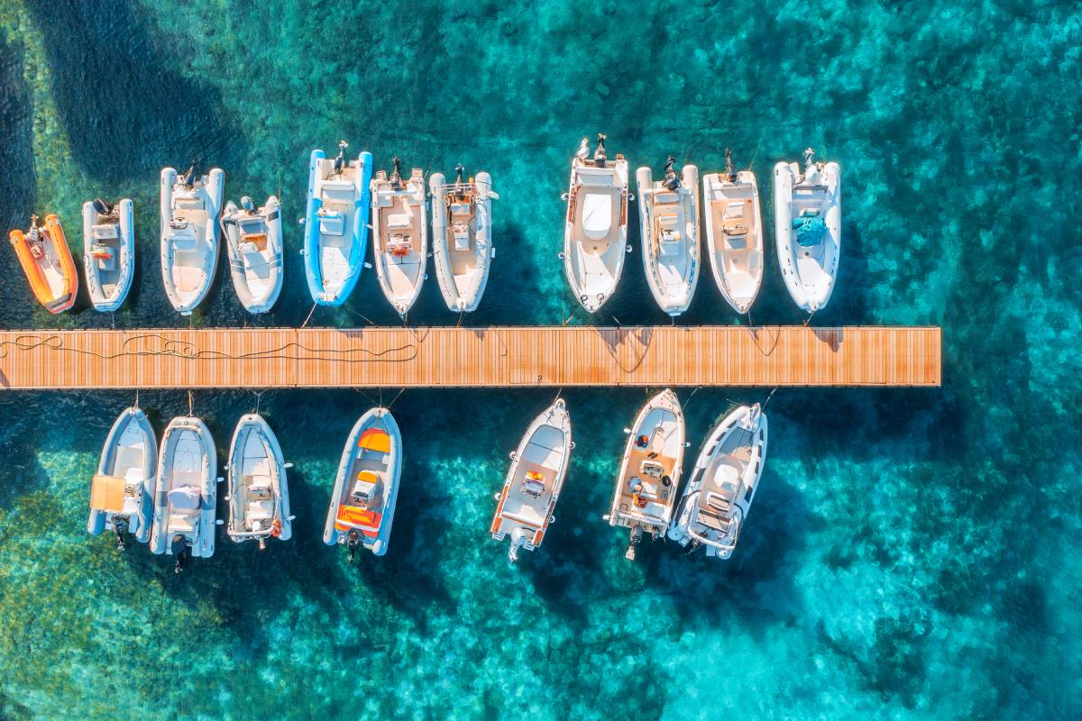 Aerial view of boats and yachts in dock at sunset in summer